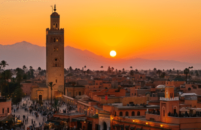 Things to Do in Marrakech– panoramic view of Marrakech Medina with Koutoubia Mosque and Atlas Mountains at sunset.